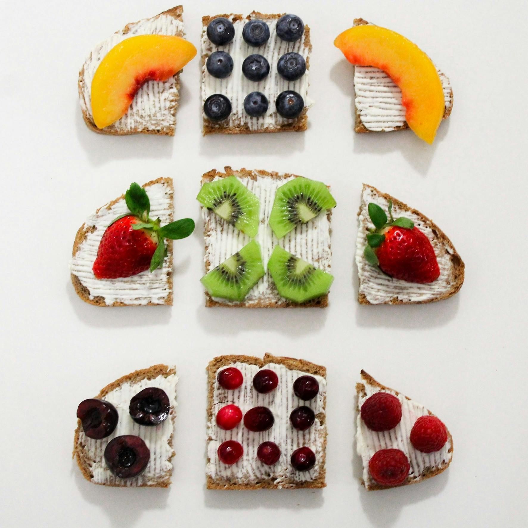 open-faced toasts with cream cheese and fruit, berries, peaches, kiwi, cherries, and raspberries.– healthy recipes