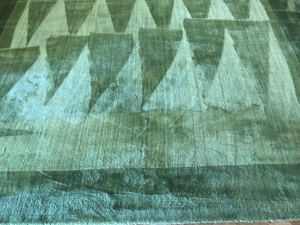 Teal and gray geometric pattern resembling triangular peaks or tents on a textured surface