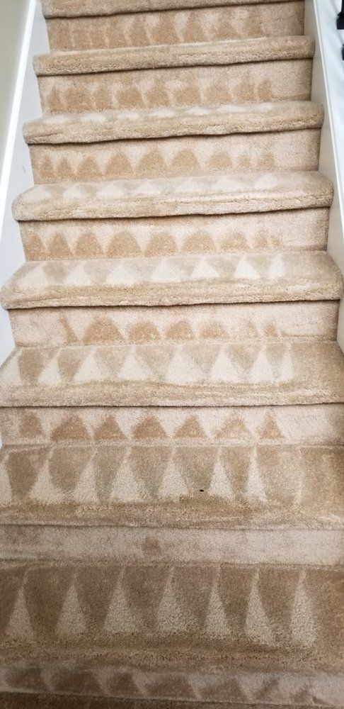 Beige patterned carpeted staircase viewed from below