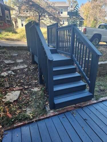 A blue deck with stairs leading up to it.