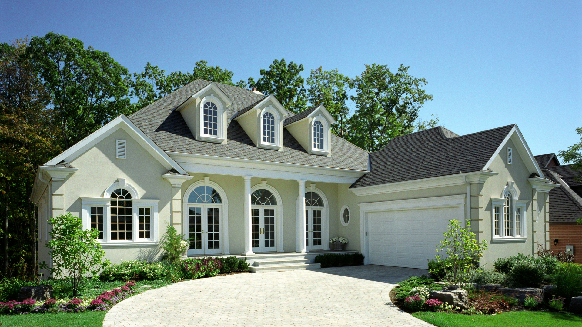 A large white house with a driveway leading to it