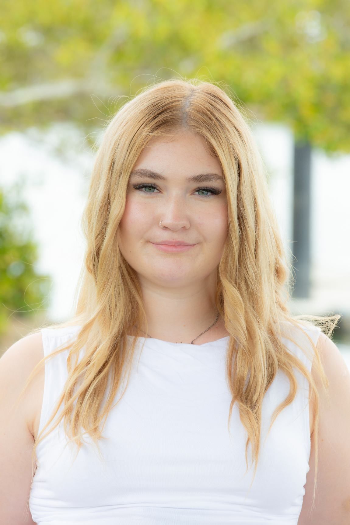 Young Woman With Long Blonde Hair, Wearing a White Top — Daly Legal In Macksville, NSW