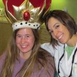 Woman in a crown and another smiling beside her at a festive event