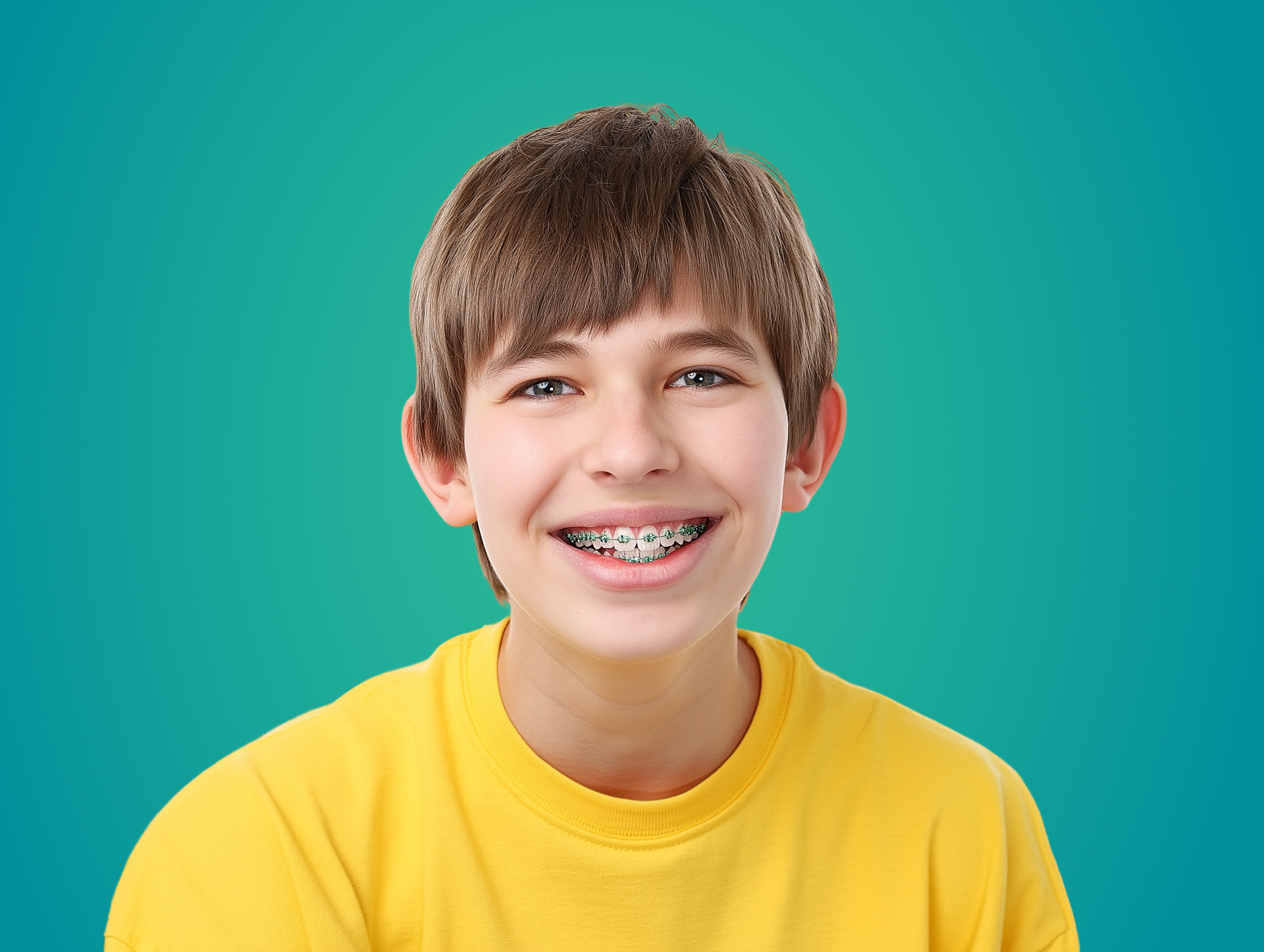 Smiling teen with braces wearing a yellow shirt against a teal background
