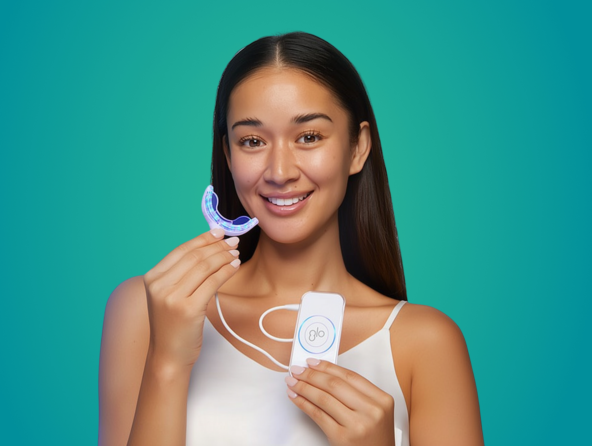 Smiling woman holding a whitening device and product against a teal background