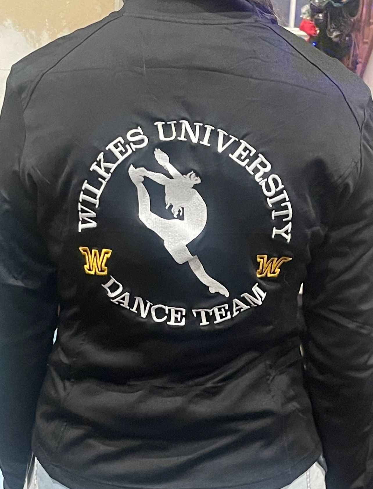 A person wearing a black jacket with 