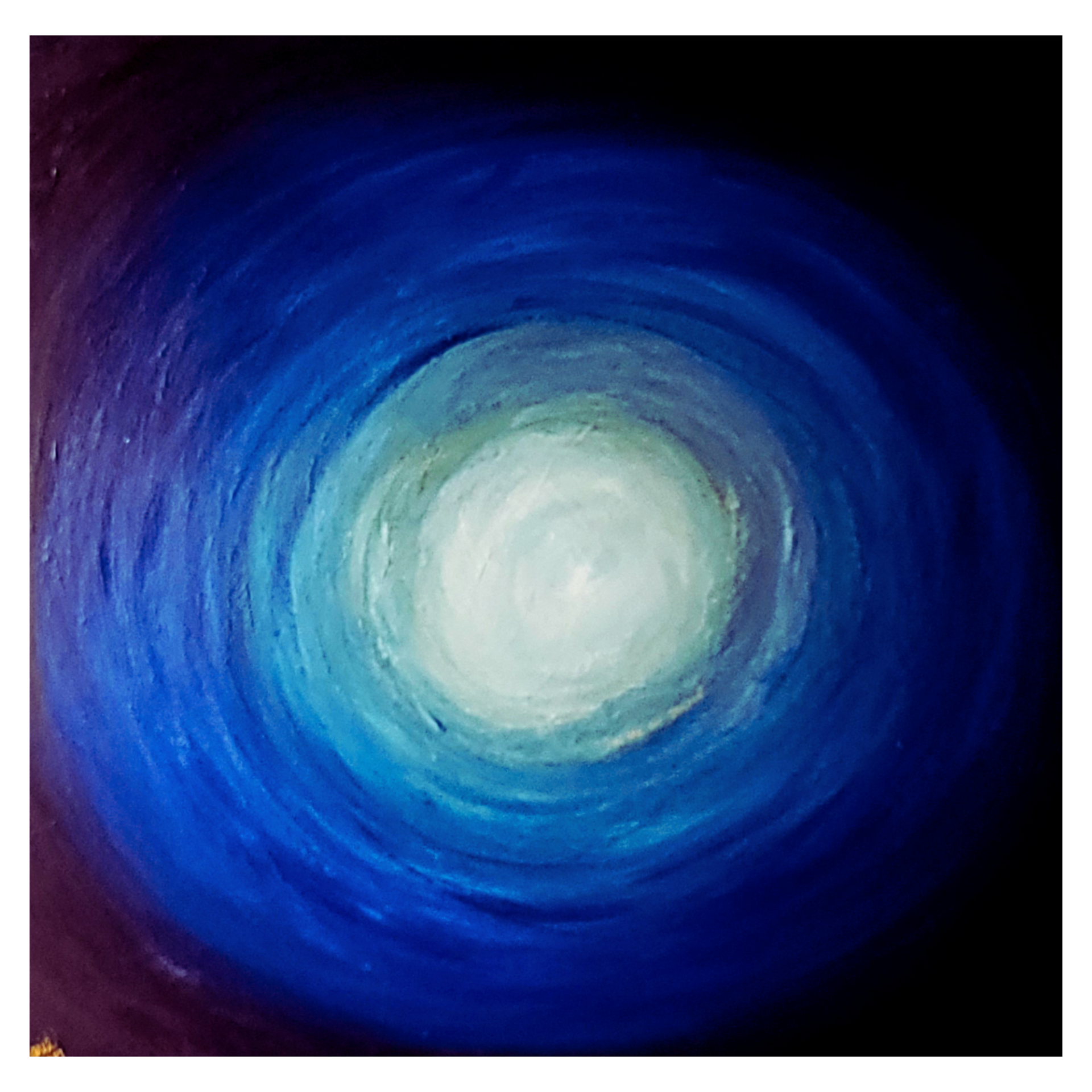 Abstract blue and purple spiral with a bright white center on a dark background