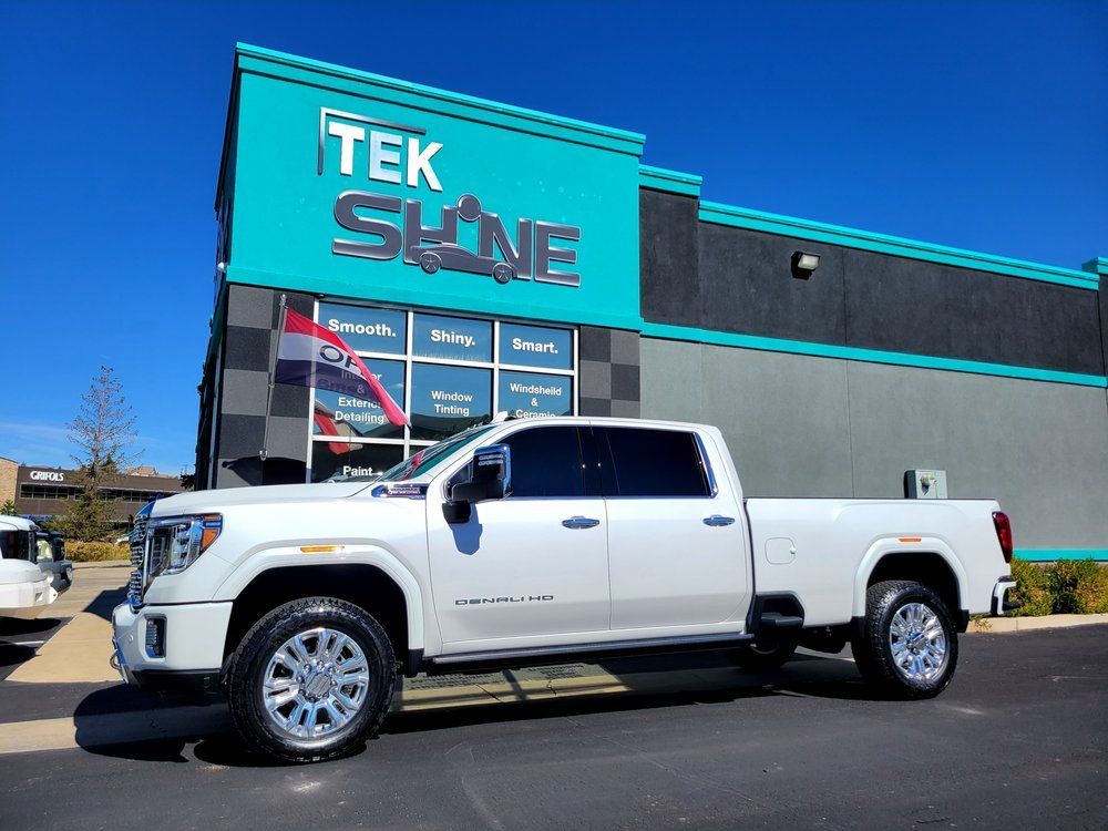 White GMC pickup truck parked outside a 