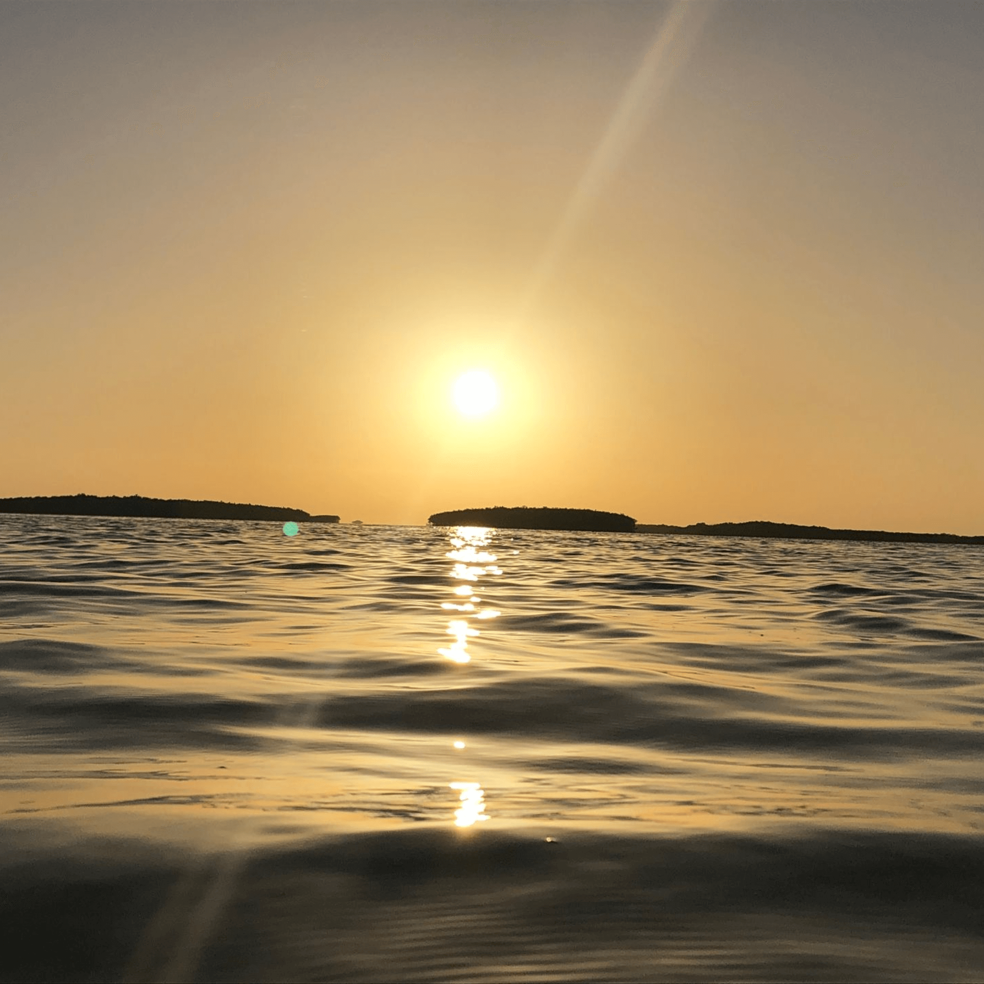The sun is setting over a body of water