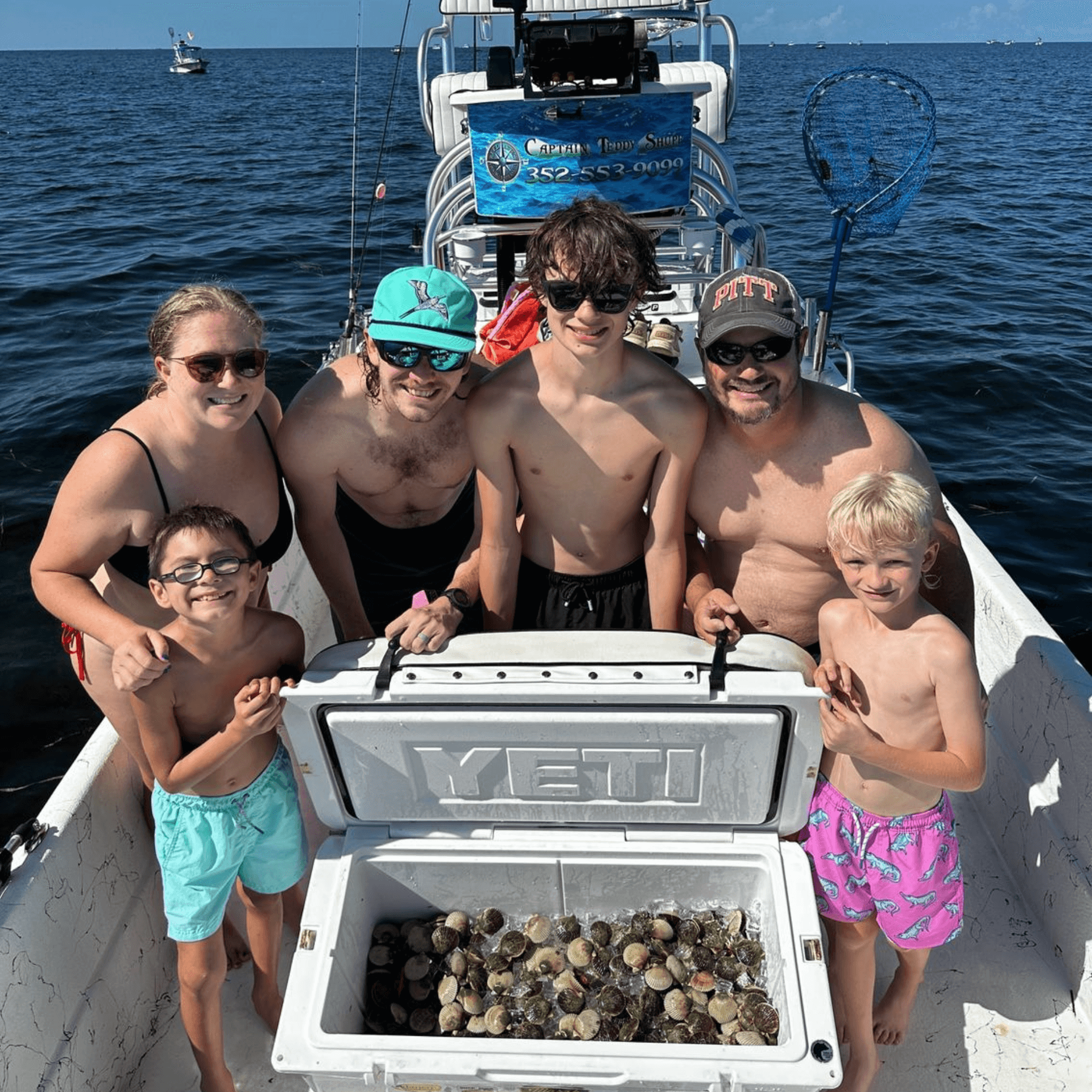 A family is posing for a picture on a boat.