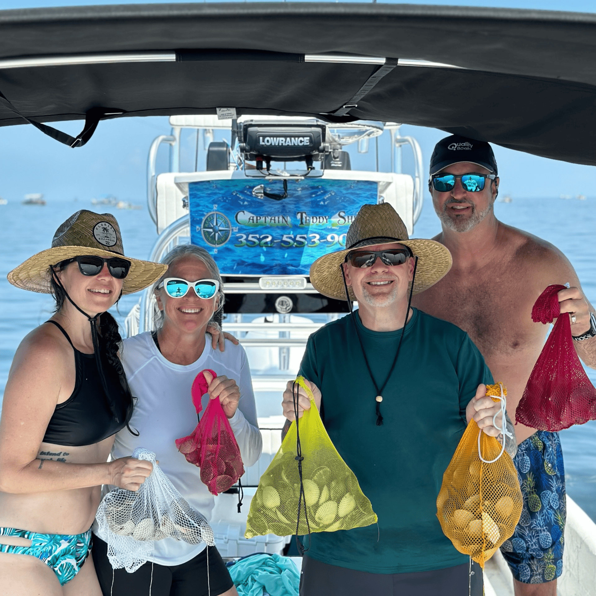A group of people standing on a boat holding bags of scallops