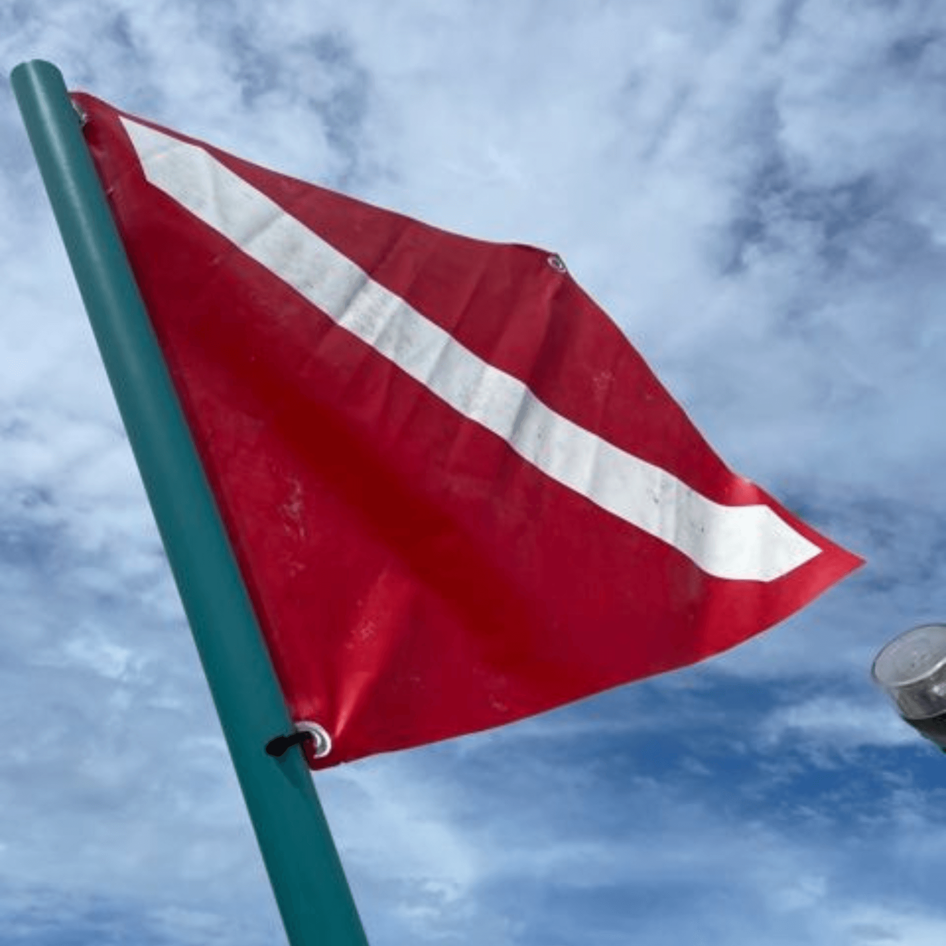 A red dive flag with a white stripe on it