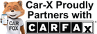 Car-X fox mascot proudly partners with CARFAX. Fox holds phone, smiling. Black and white logo.
