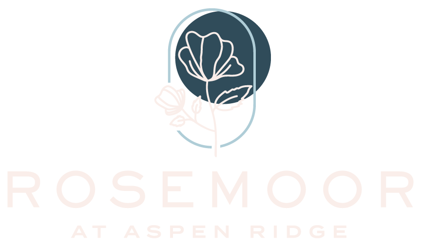Logo for Rosemoor at Aspen Ridge with a dark teal flower emblem and pale pink text