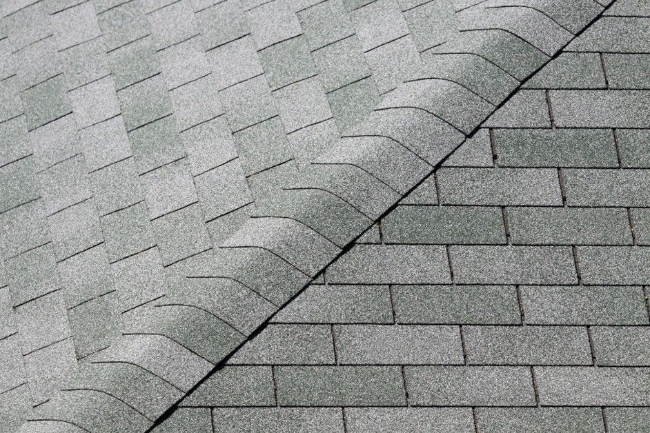 Gray asphalt roof shingles with a diagonal ridge line and overlapping pattern