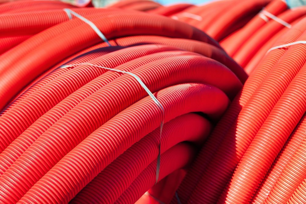 Bundle of Red Corrugated Pipes — Cessnock Landscaping Supplies In Cessnock, NSW