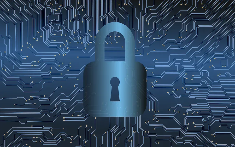A blue padlock is sitting on top of a circuit board.