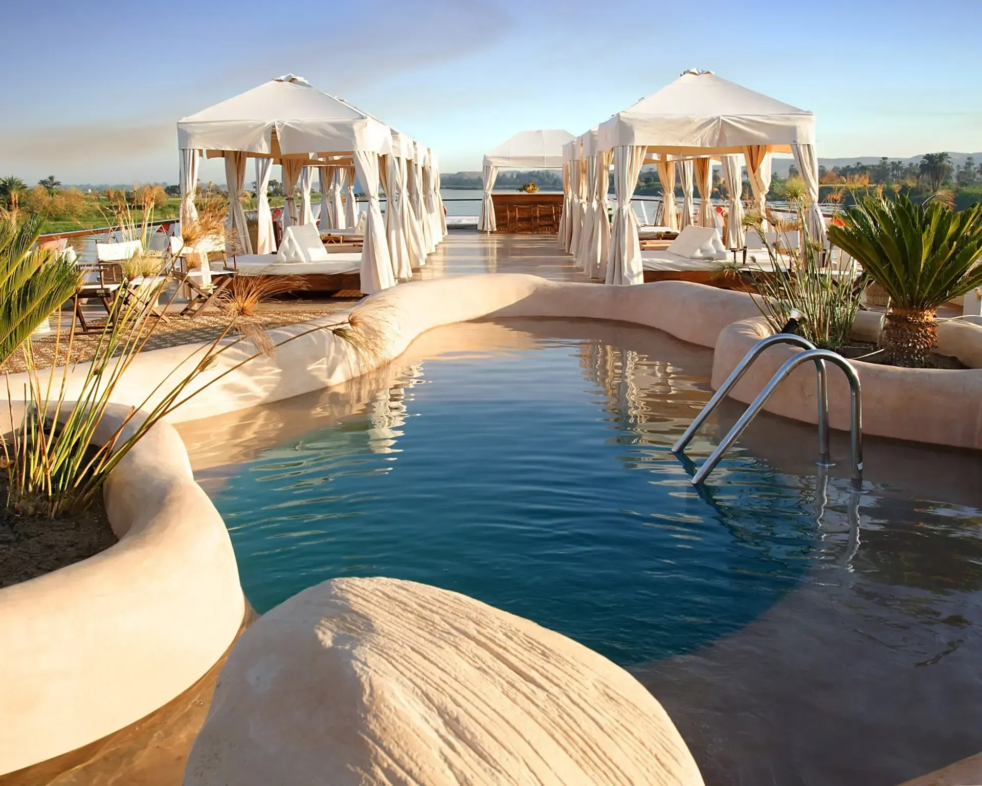 A large swimming pool with a ladder leading to it on Abercrombie & Kent's Sun Boat III.
