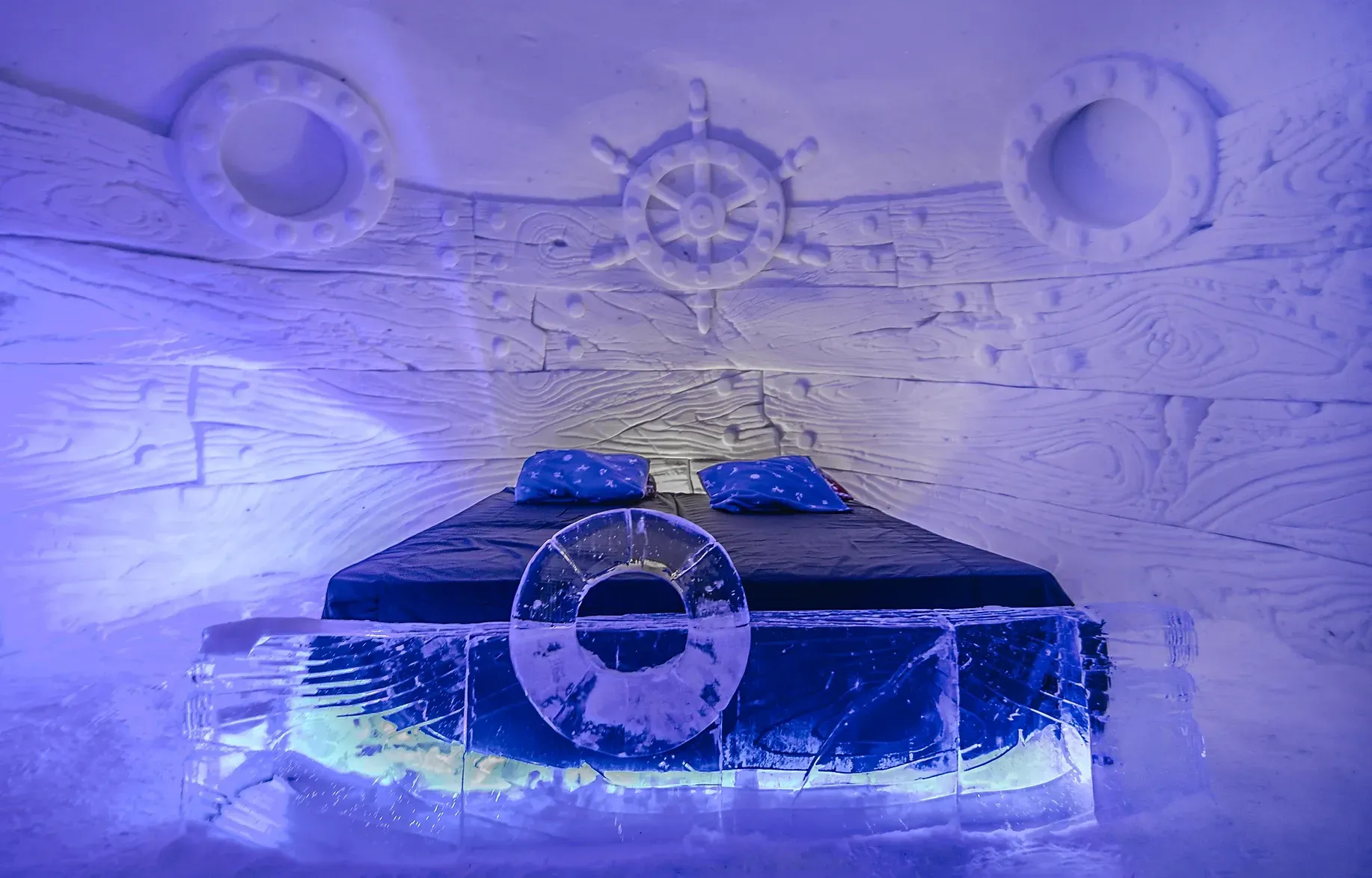A bed inside of an igloo at the snow hotel in Norway.