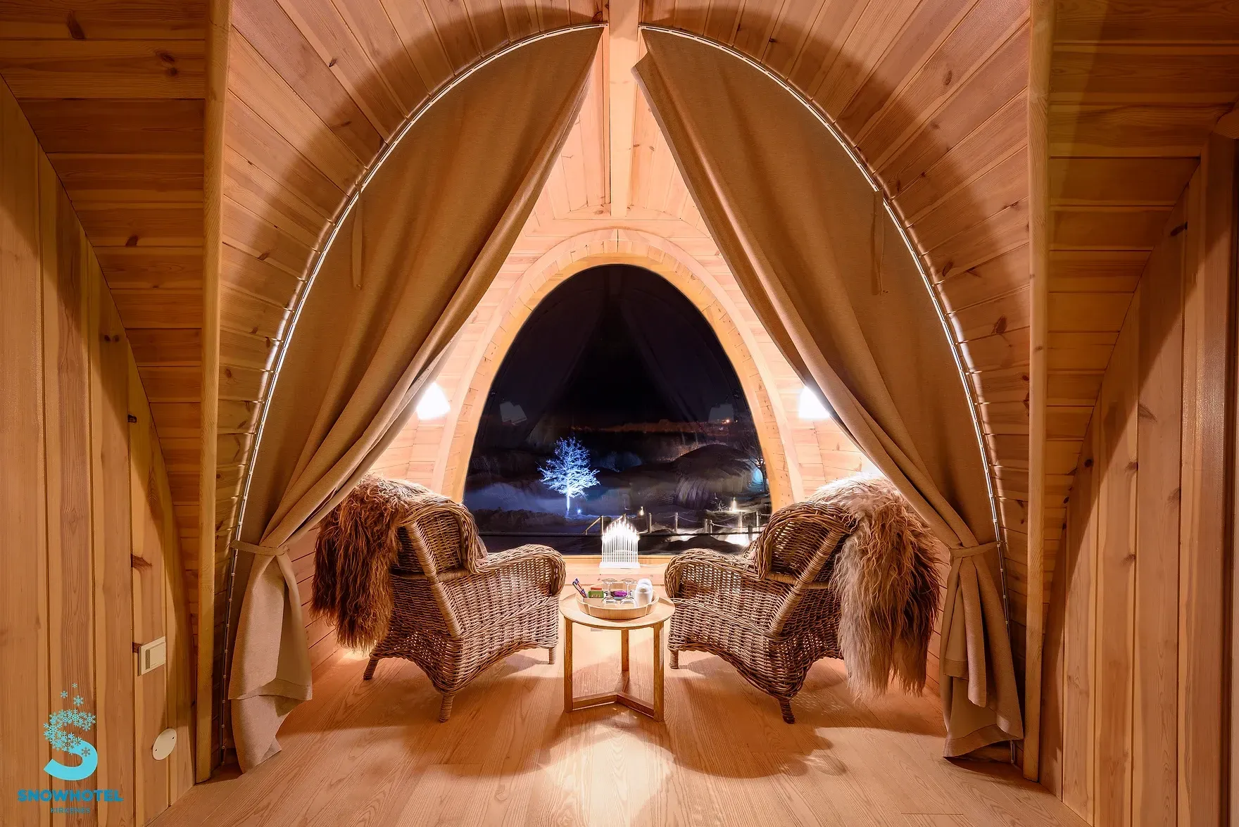 A wooden room with two chairs and a table in it in Norway.