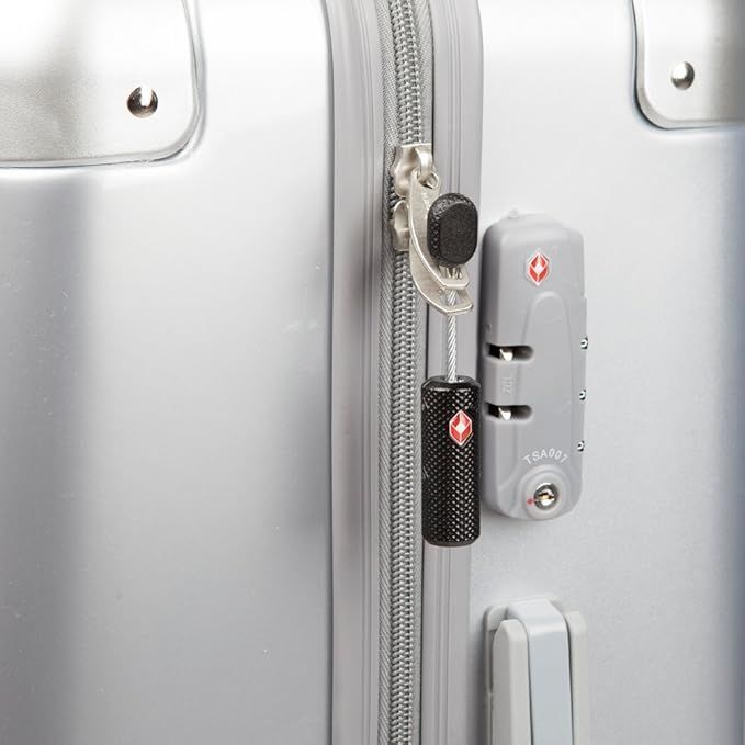 A close up of a silver suitcase with a lock on it.