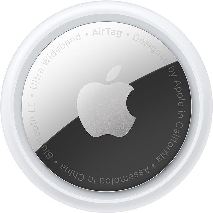 The back of a white apple airtag with a black apple logo on it.