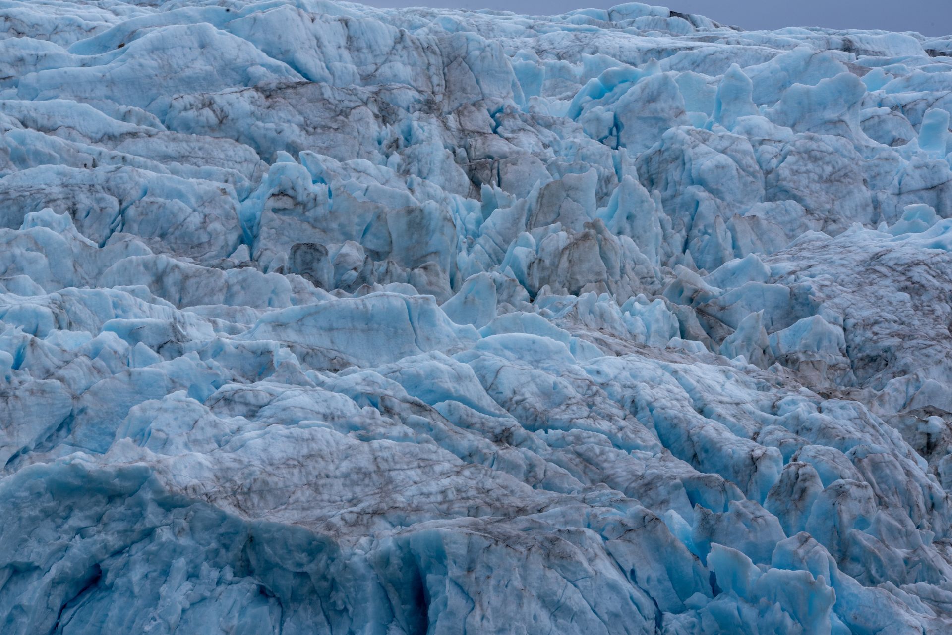 A close up of a glacier with a lot of ice on it in Svalbard.