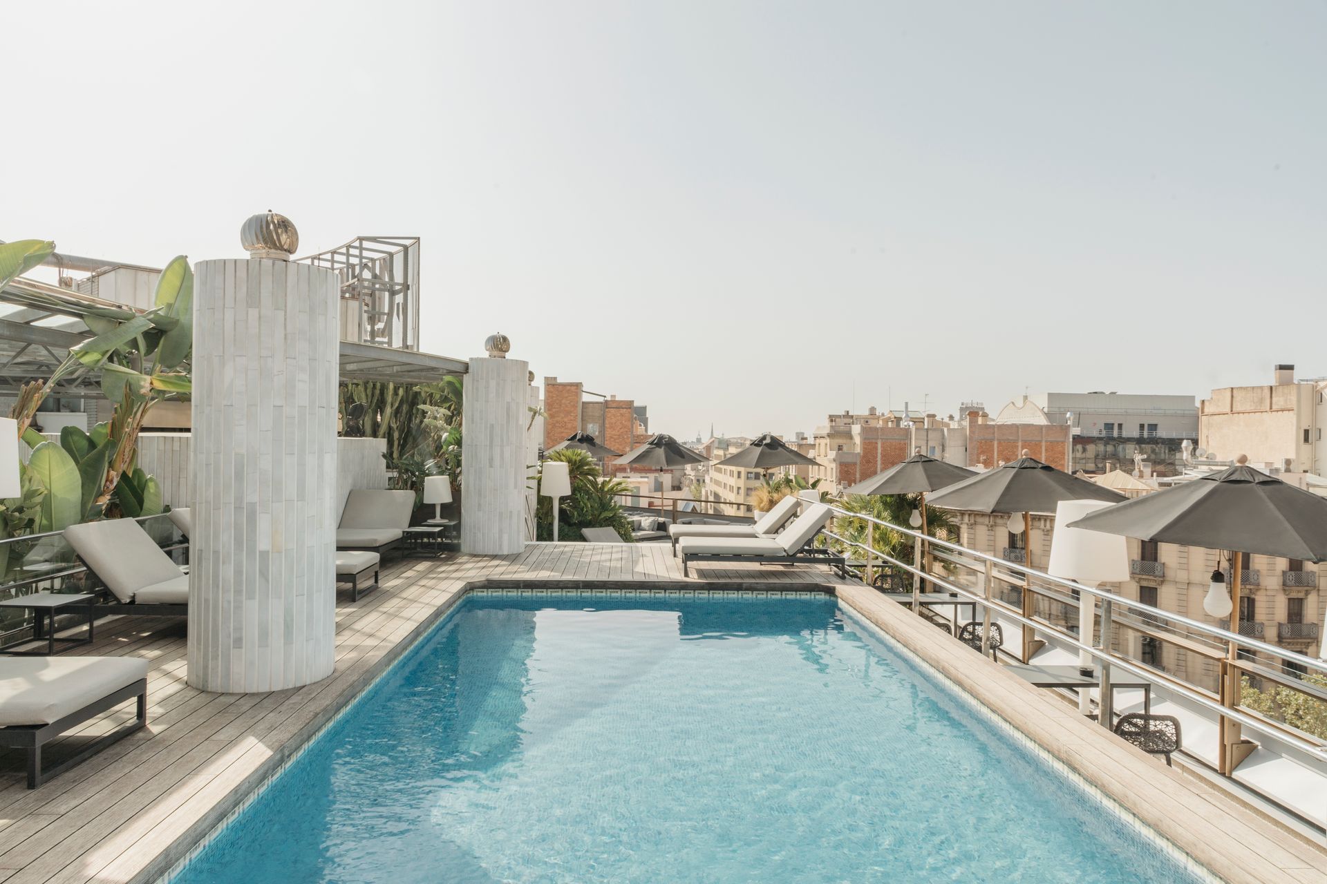 There is a large swimming pool on the roof of a building at Claris Hotel & Spa in Barcelona, Spain