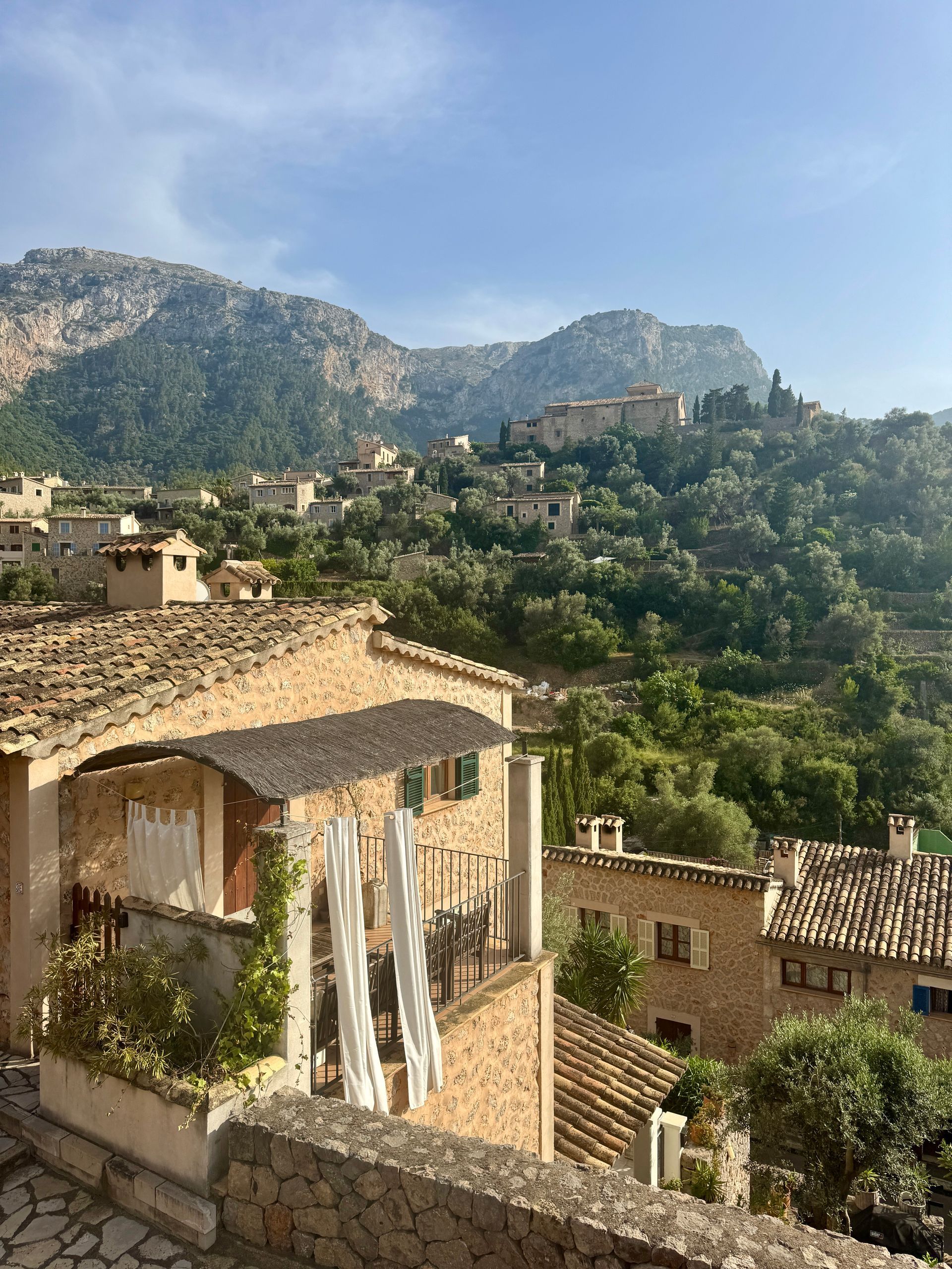 Stone buildings and mountains in the village of Deià in Majorca, Spain.