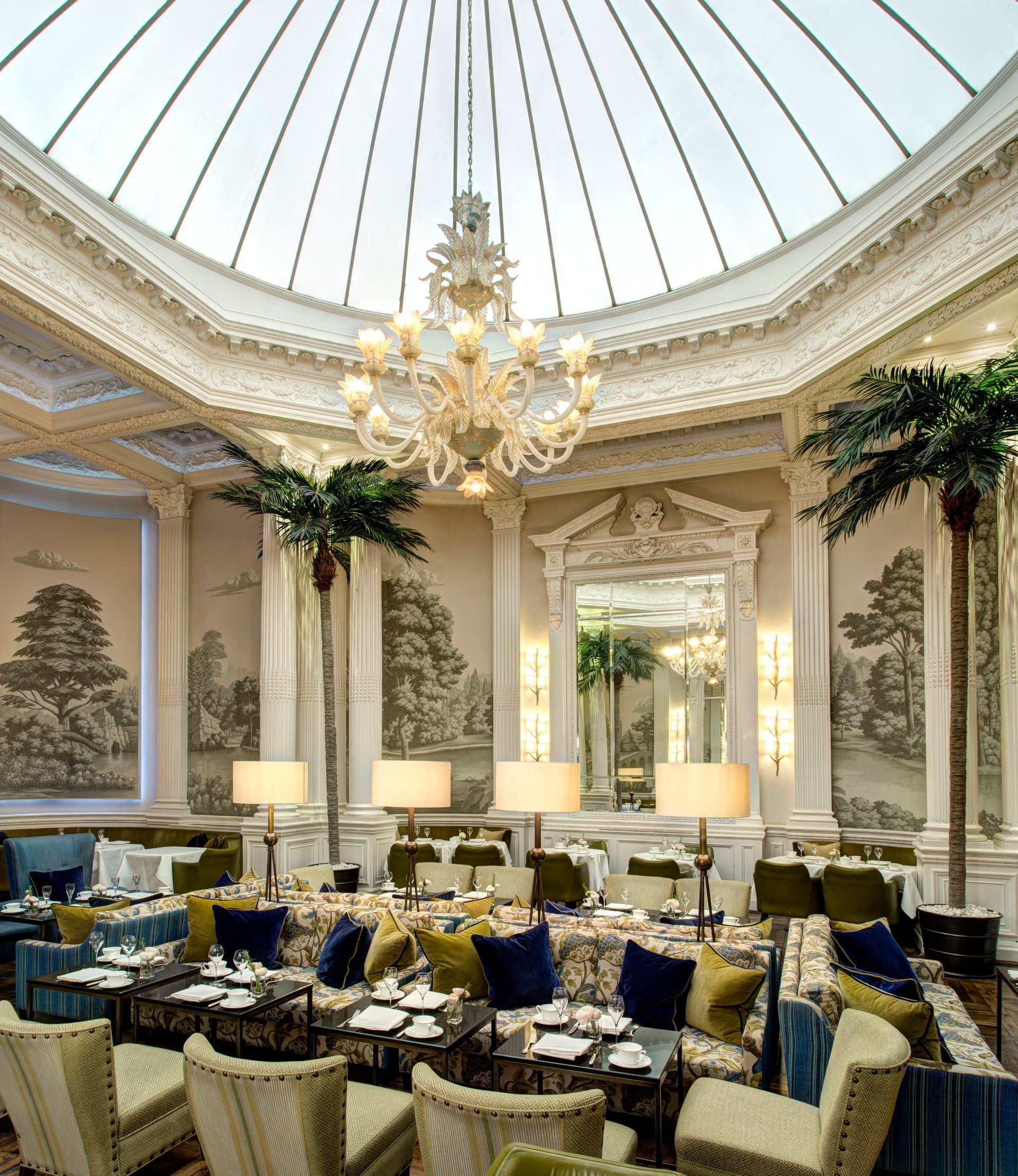 A large room with tables and chairs and a chandelier hanging from the ceiling at Edinburgh Rocco Forte Hotel.