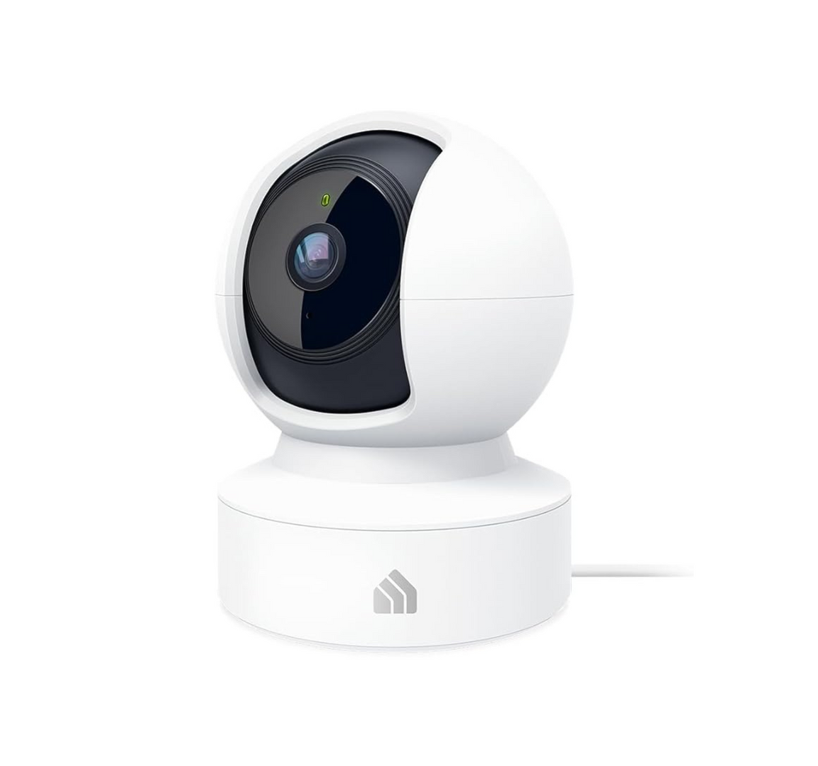 A white camera with a black lens is sitting on a white surface.