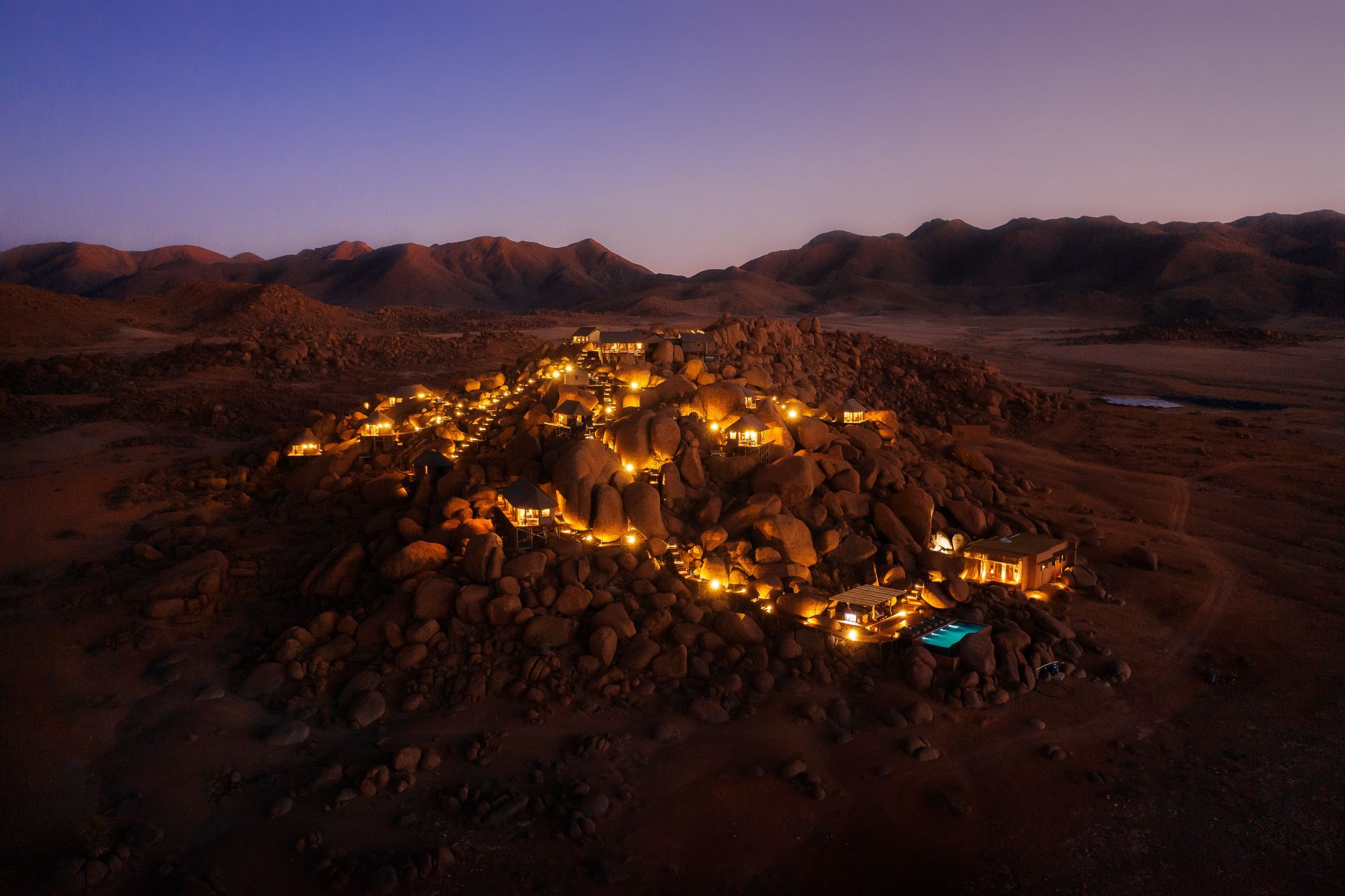 An aerial view of a desert landscape at night with mountains in the background in Namibia, Africa.