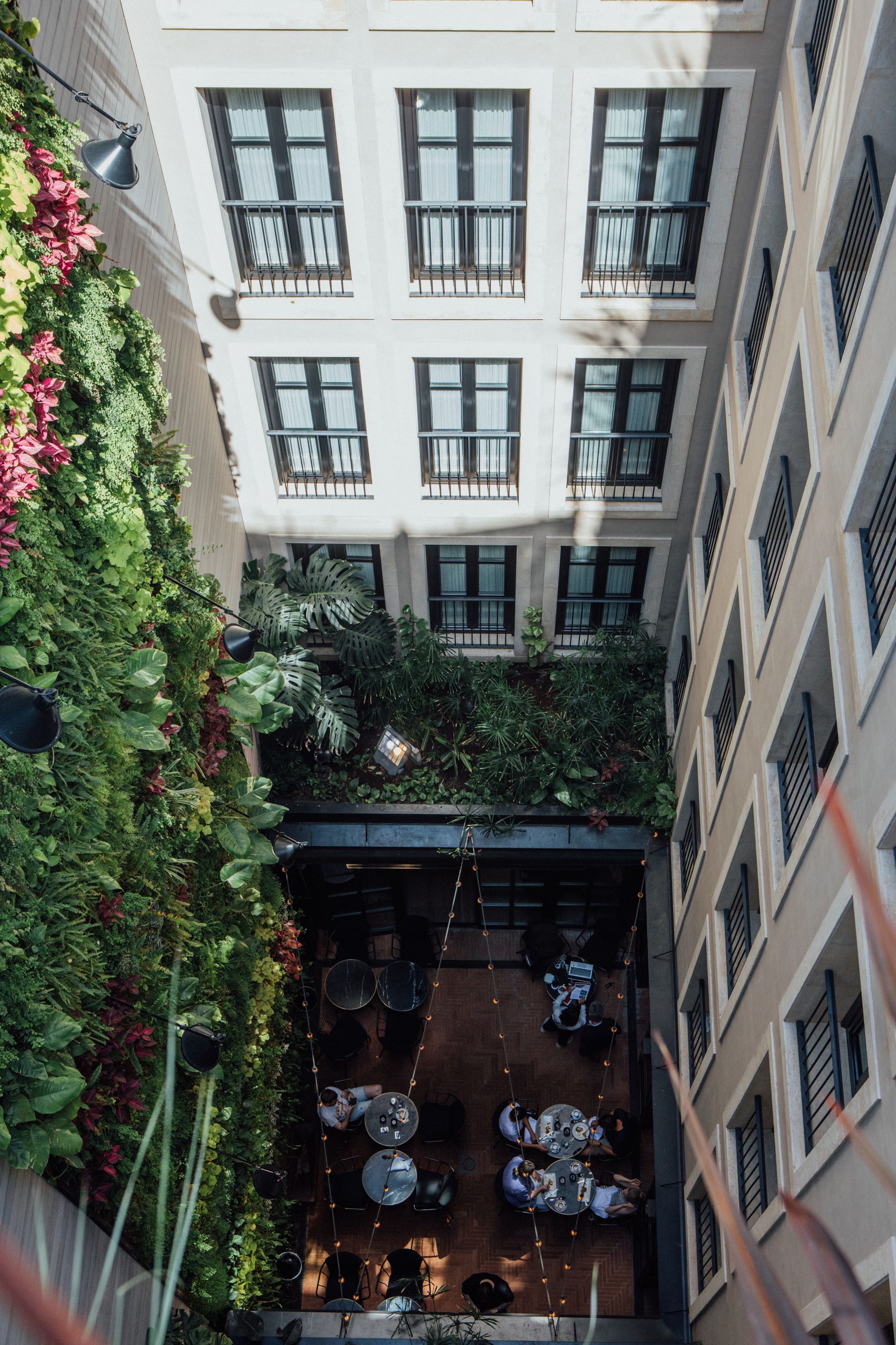 An aerial view of a building with tables and chairs in the middle of it at Wittmore Hotel in Barcelona, Spain.