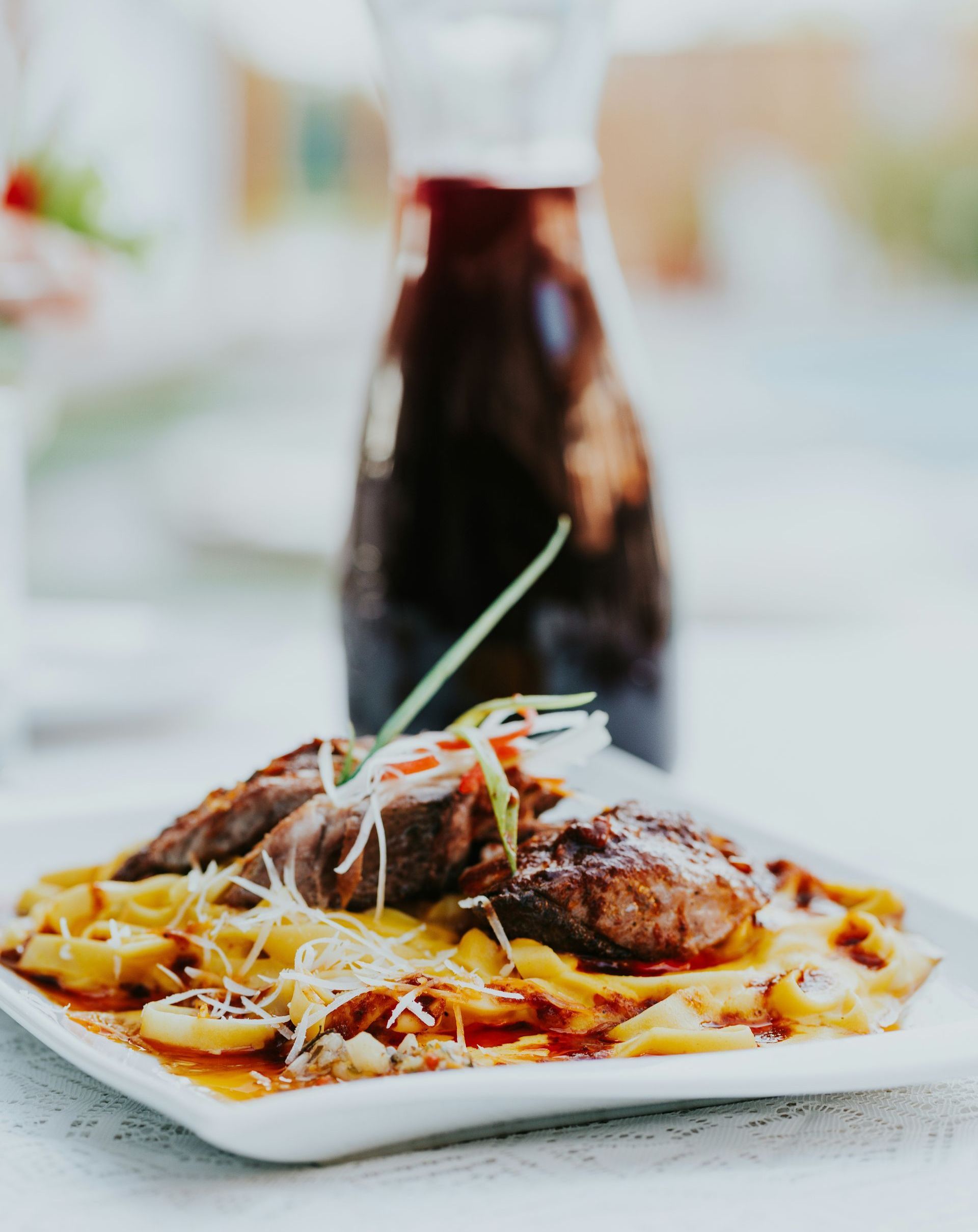 A plate of traditional Peruvian food with a bottle in the background in Peru.
