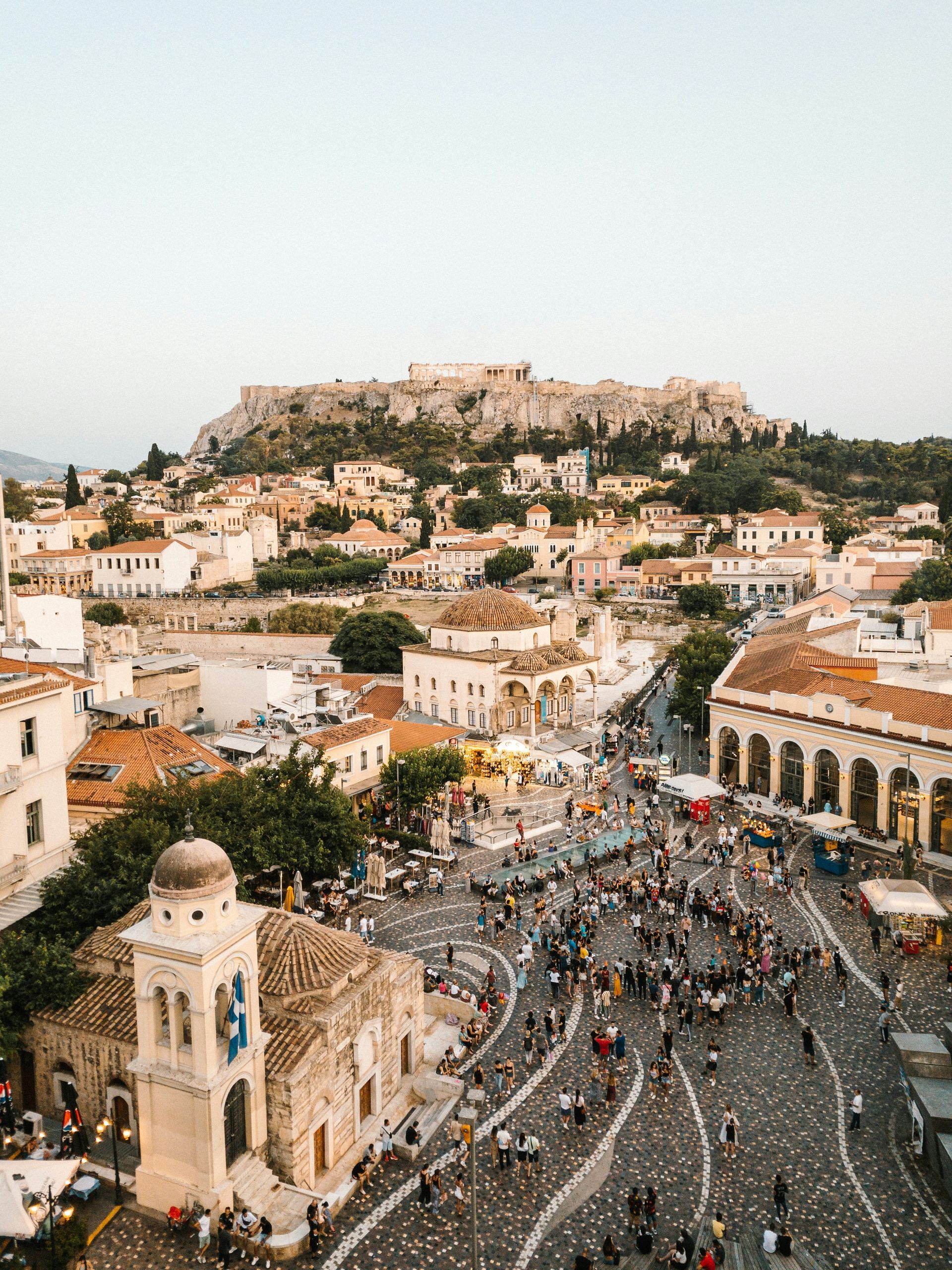 An aerial view of Athens, Greece with a mountain in the background.