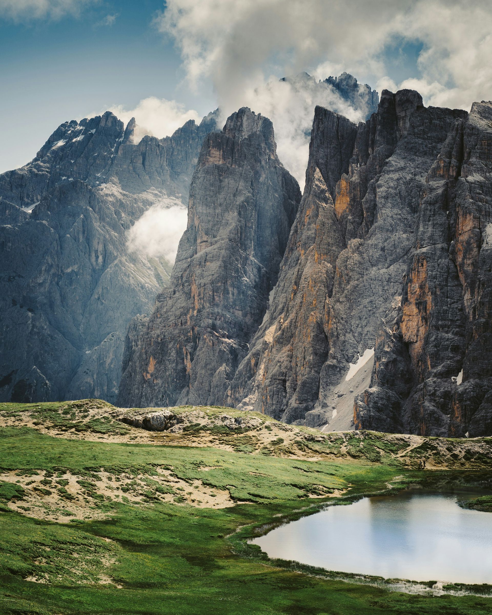 The Dolomites with a lake in the middle of it in Italy.