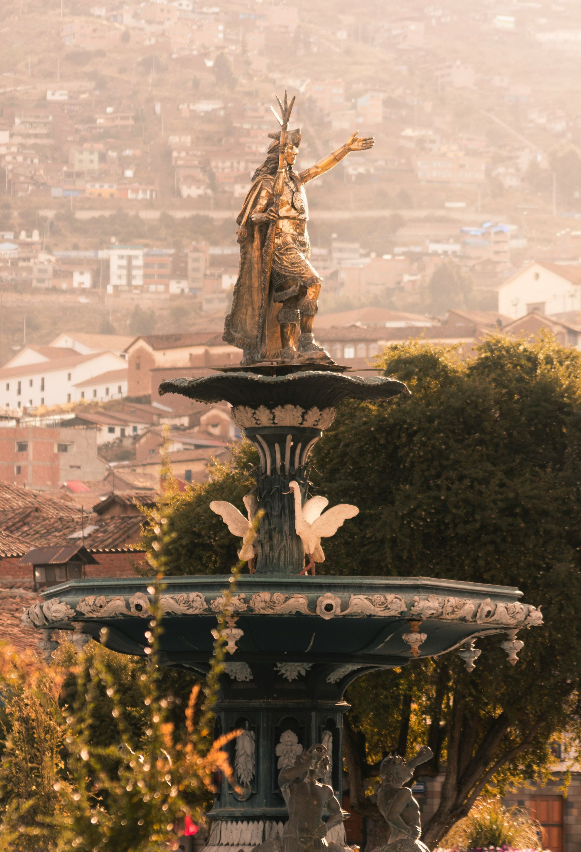 A fountain with a statue of a woman on top of it in Cusco, Peru.