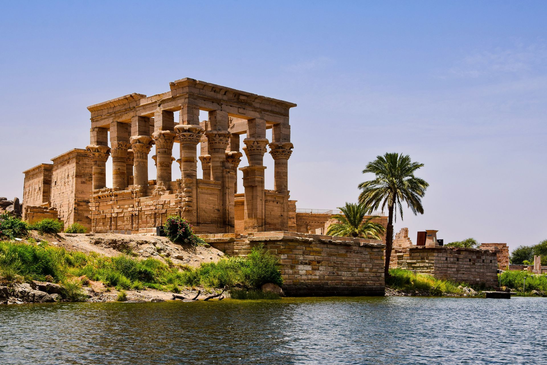 A temple is sitting on a small island in the middle of a lake in Aswan, Egypt.
