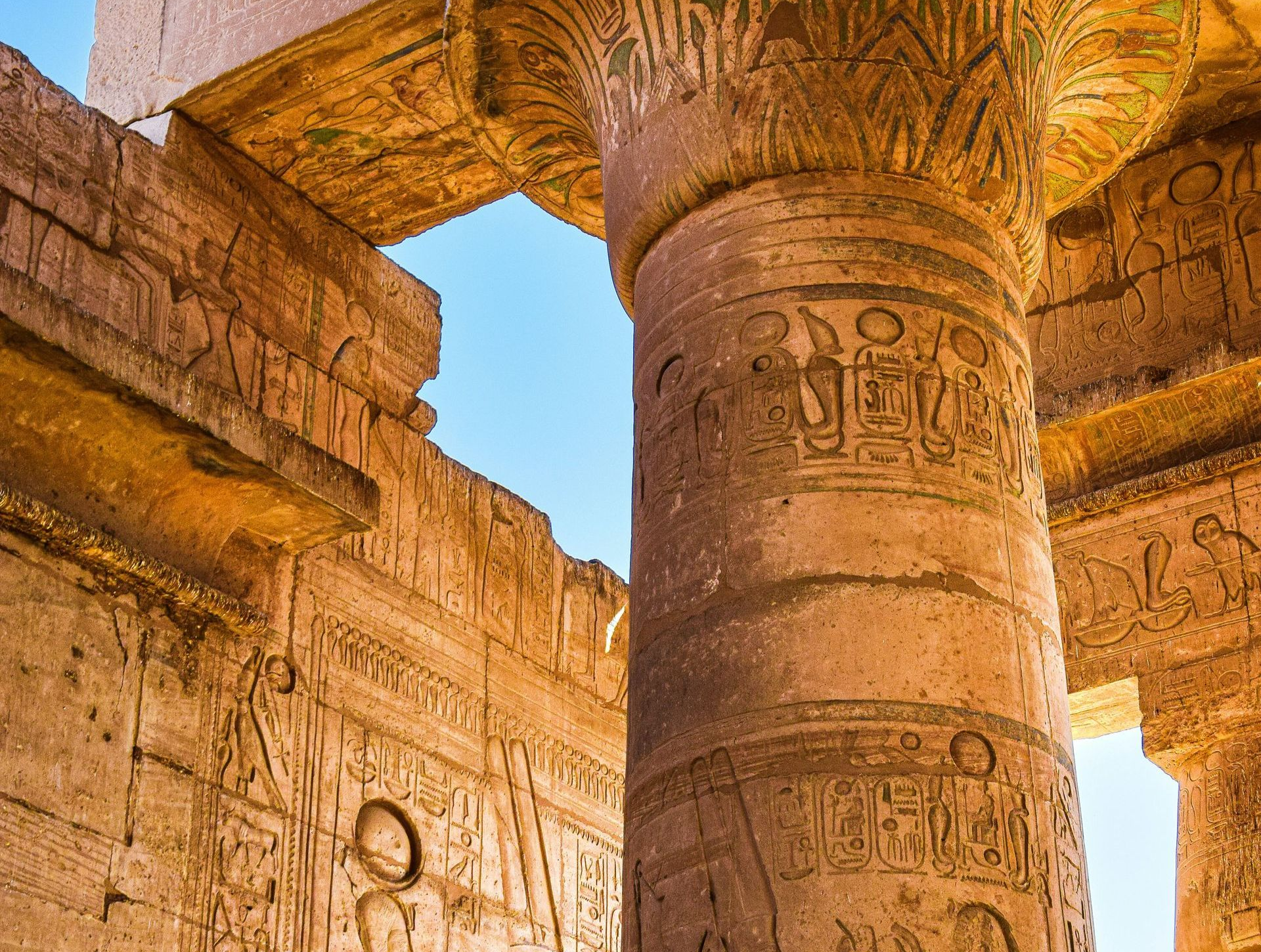 A very old building with a lot of columns and carvings on them in Luxor, Egypt.