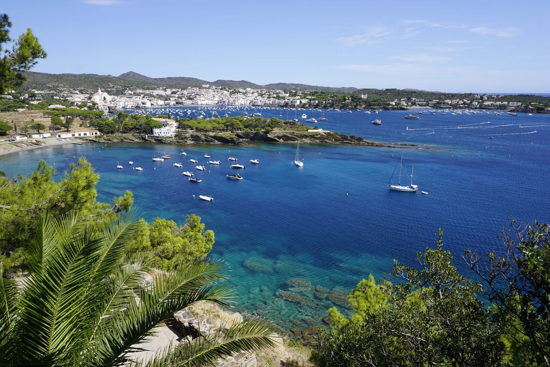 A view of a body of water with boats in it in Cadaqués, Spain.