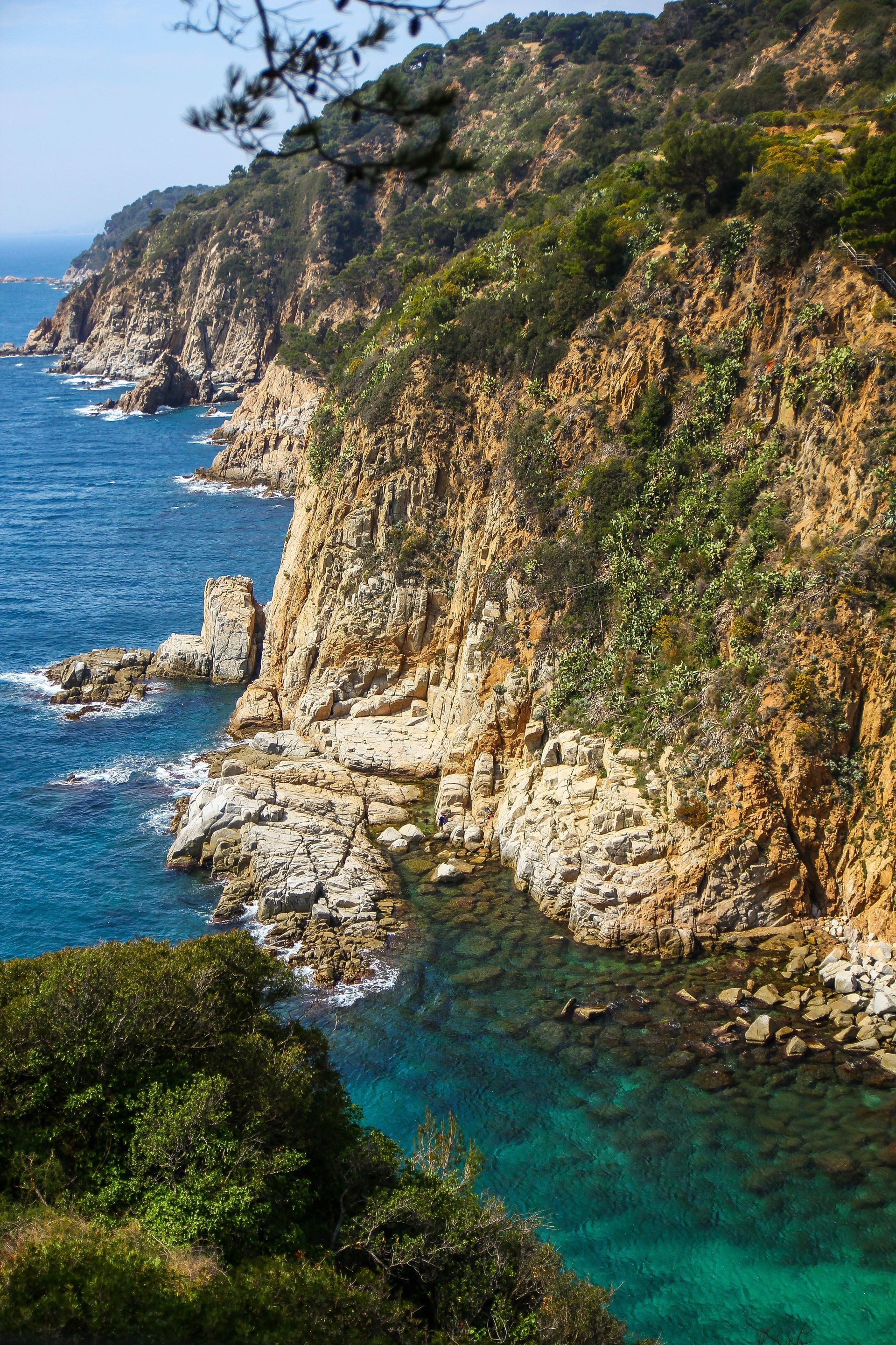 A view of a rocky cliff overlooking the ocean on Costa Brava, Spain.