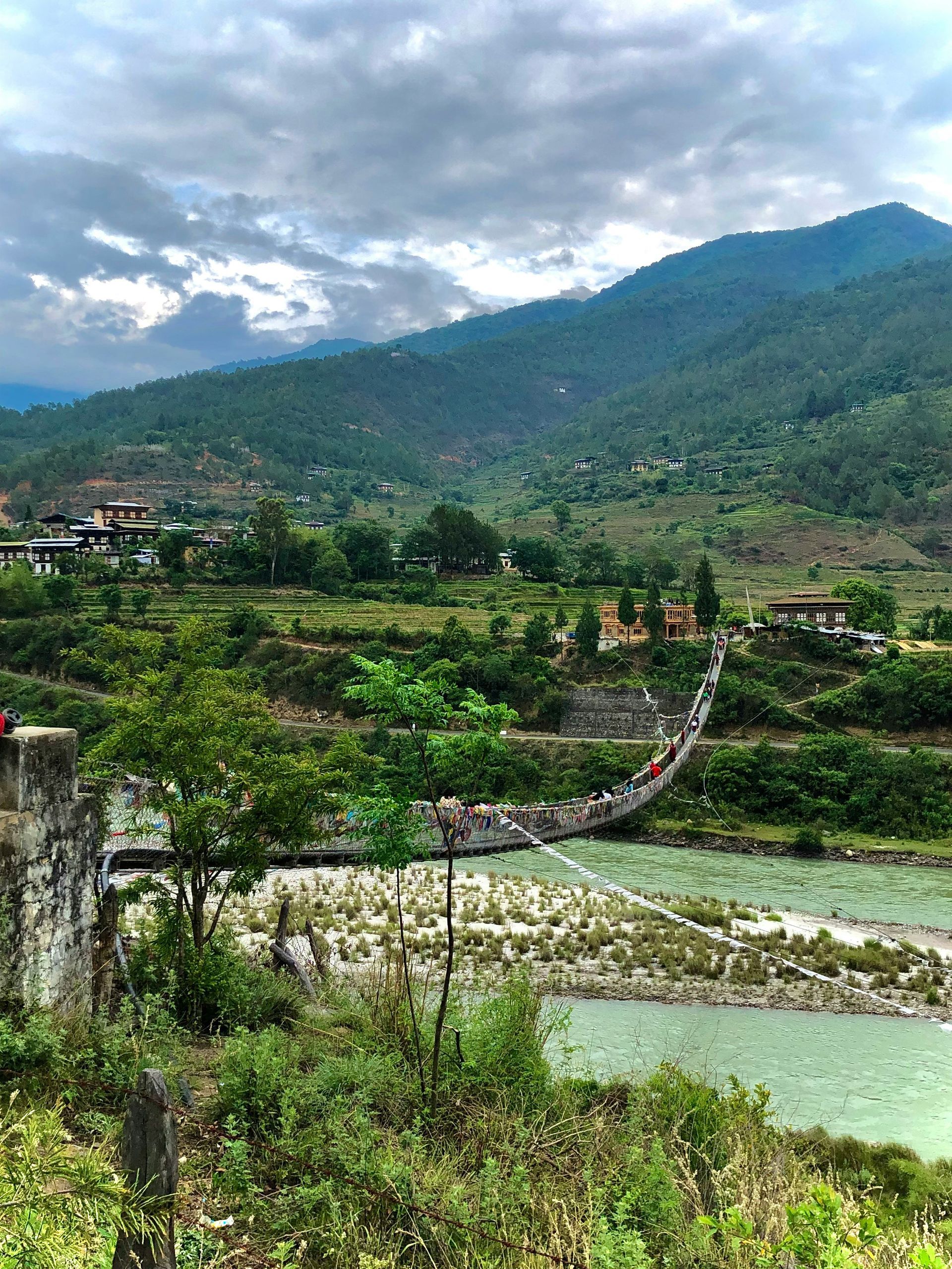 Suspension bridge over a river, connecting to the village of Punakha in Bhutan.
