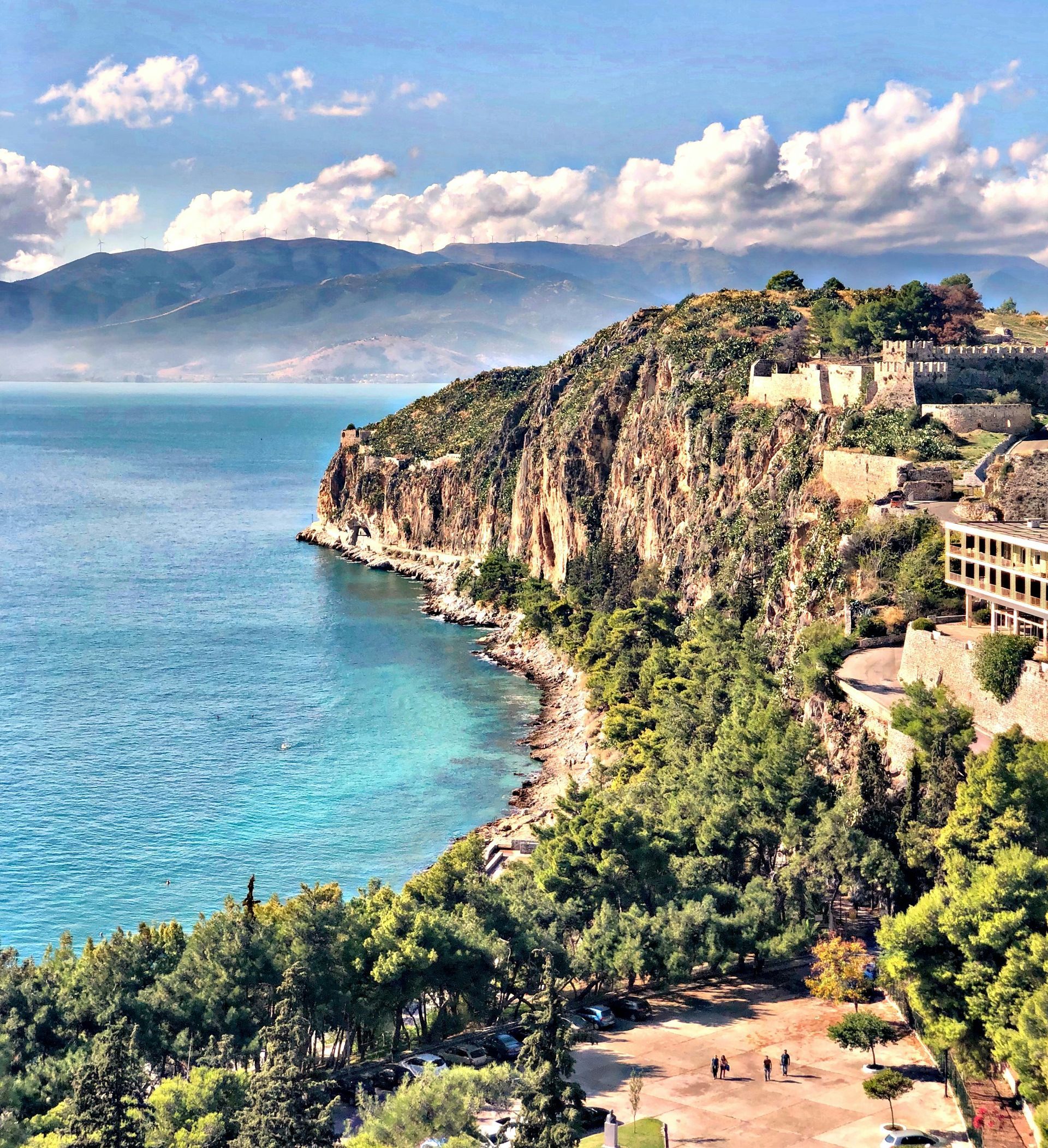 An aerial view of a cliff overlooking a body of water in the Peloponnese, Greece.