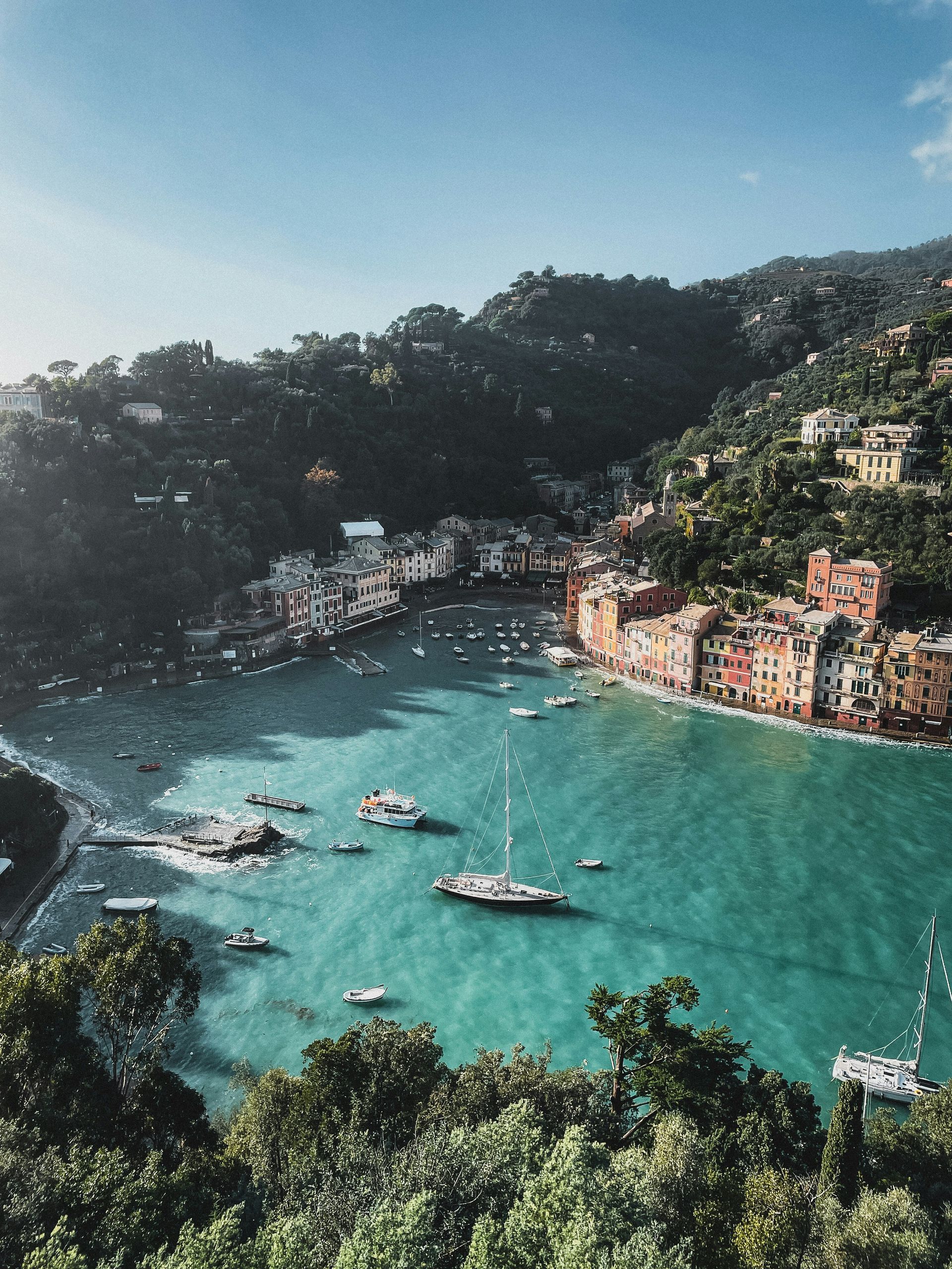 A large body of water surrounded by trees and buildings in Portofino, Italy.