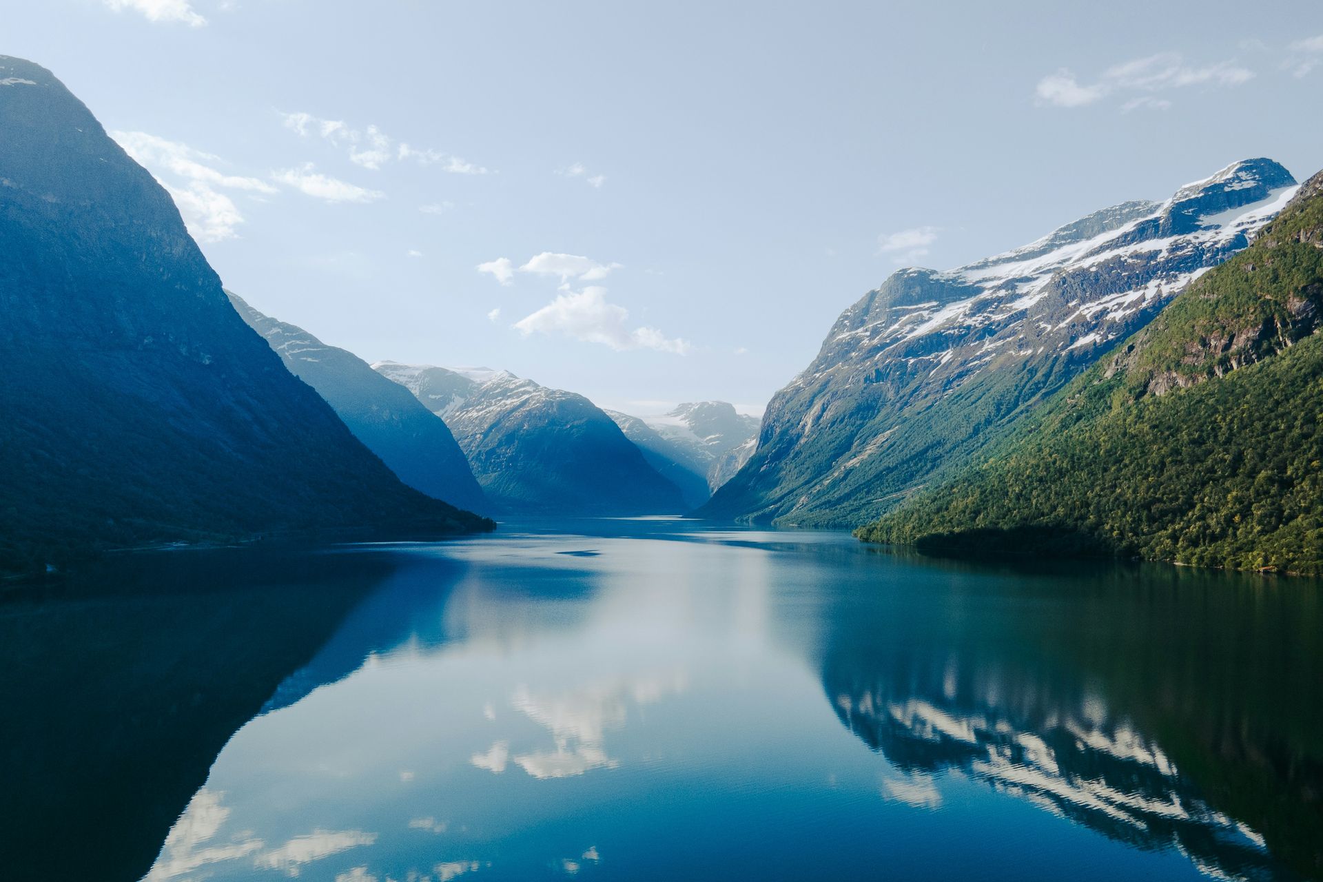 A fjord surrounded by mountains and trees in Norway.