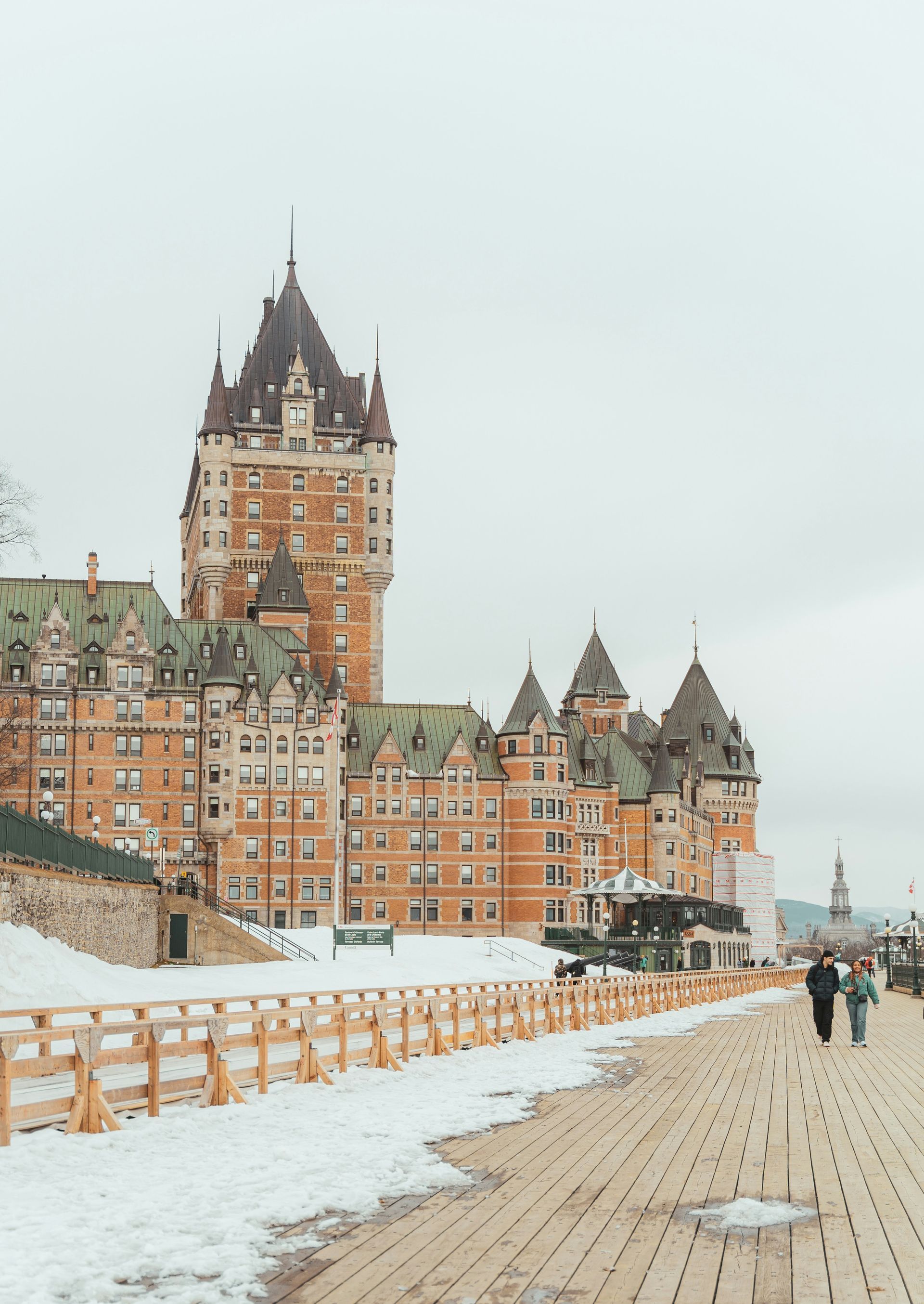 Château Frontenac in Quebec City, Canada, a large brown and green castle-like building with a wooden walkway.
