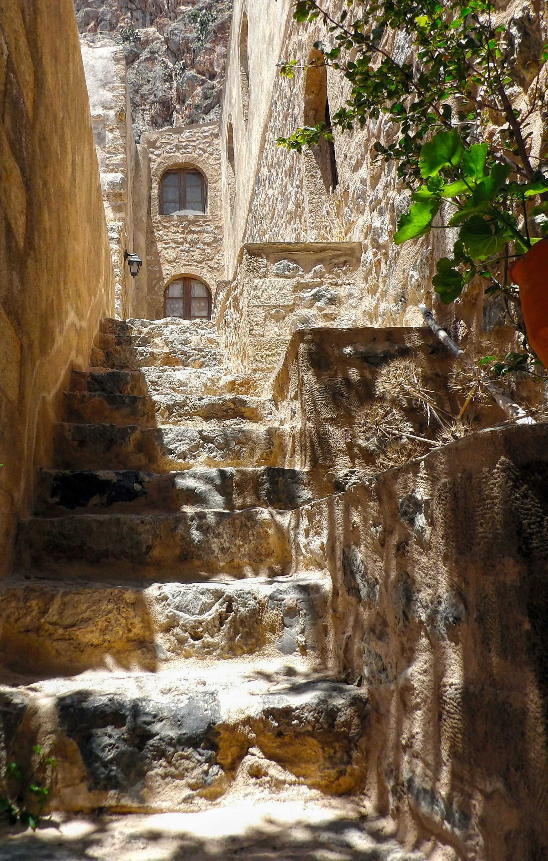 A stone staircase leading up to a stone building in Peloponnese, Greece.