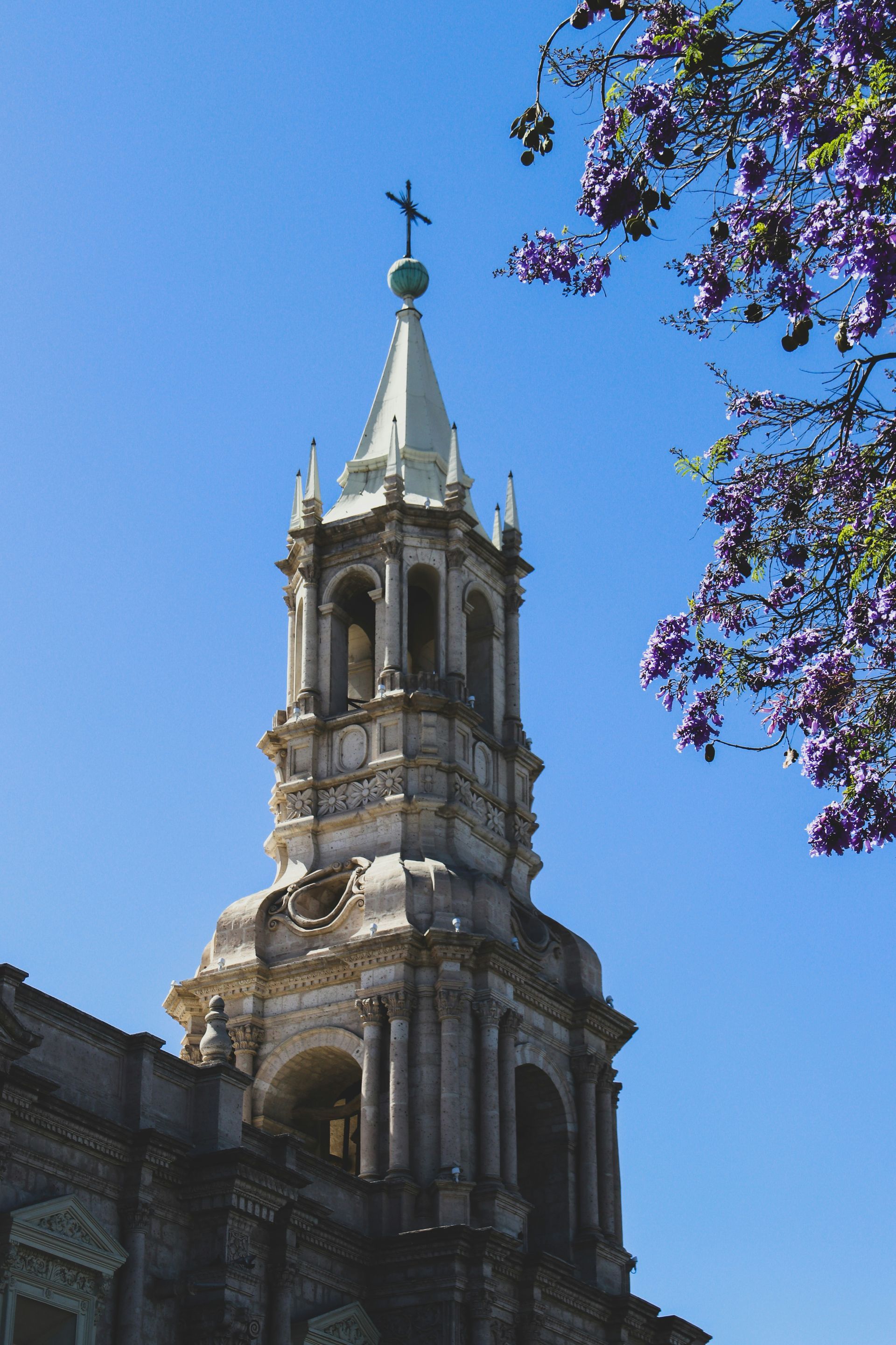 A church tower with a cross on top of it in Arequipa, Peru.