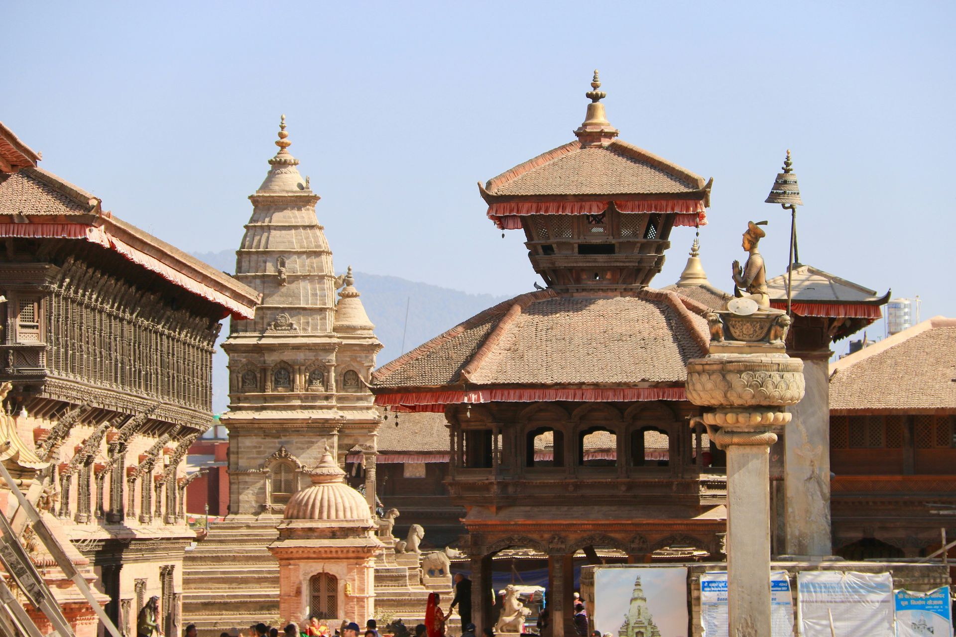 Traditional Nepalese architecture: ornate wooden temples and pagodas in a plaza in Bhaktapur, Nepal.