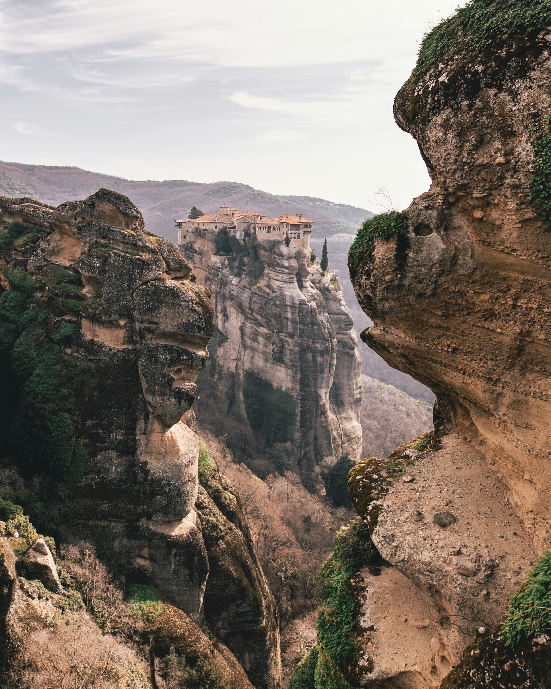 A view of a cliff with the Meteora Monastery on top of it in Kalabaka, Greece.